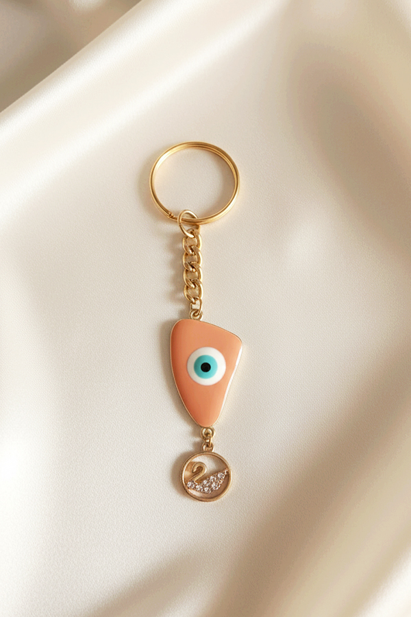 Chic Gold Evil Eye Keychain with Swan Charm in Soft Peach Enamel