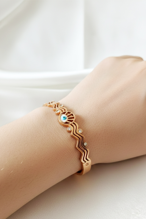 Elegant Rose Gold Wavy Bangle with Sunburst Evil Eye & Crystal Accents