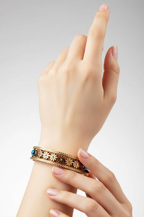 Antique Gold Floral Cutout Bangle with Blue Gemstone Accents